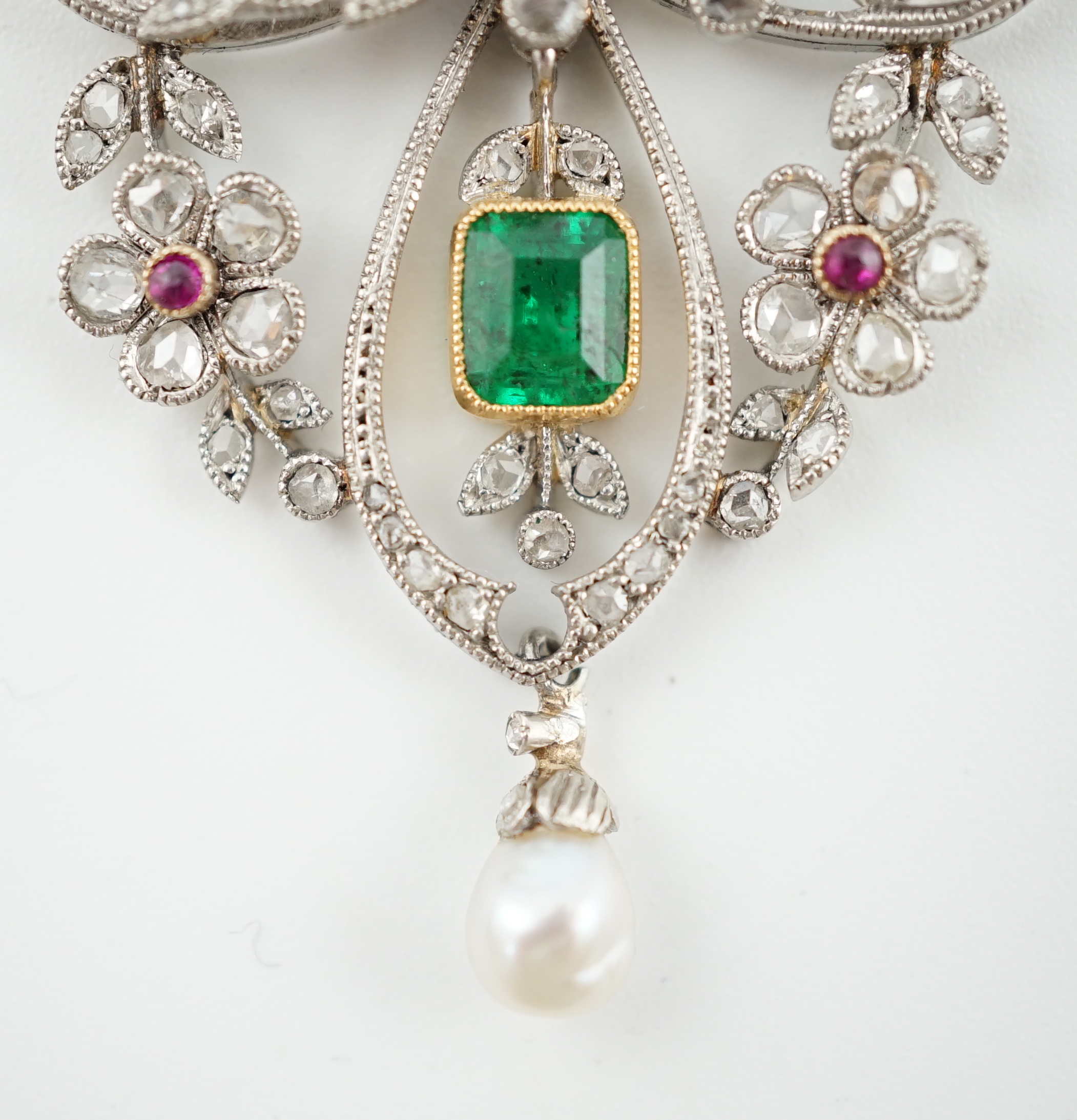 A Belle Epoque gold and platinum, emerald, pearl, ruby and diamond cluster set drop pendant brooch